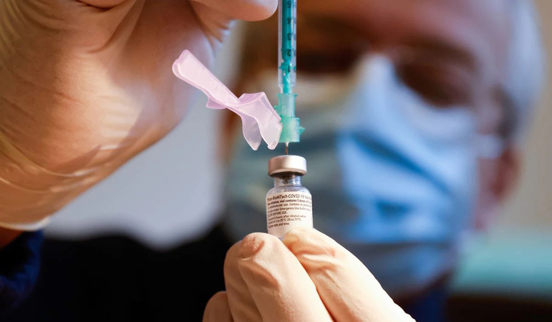 A syringe is prepared to administer the Pfizer-BioNTech coronavirus disease